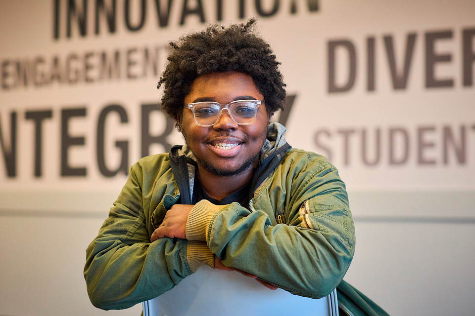 Black student sitting backwards on a chair
