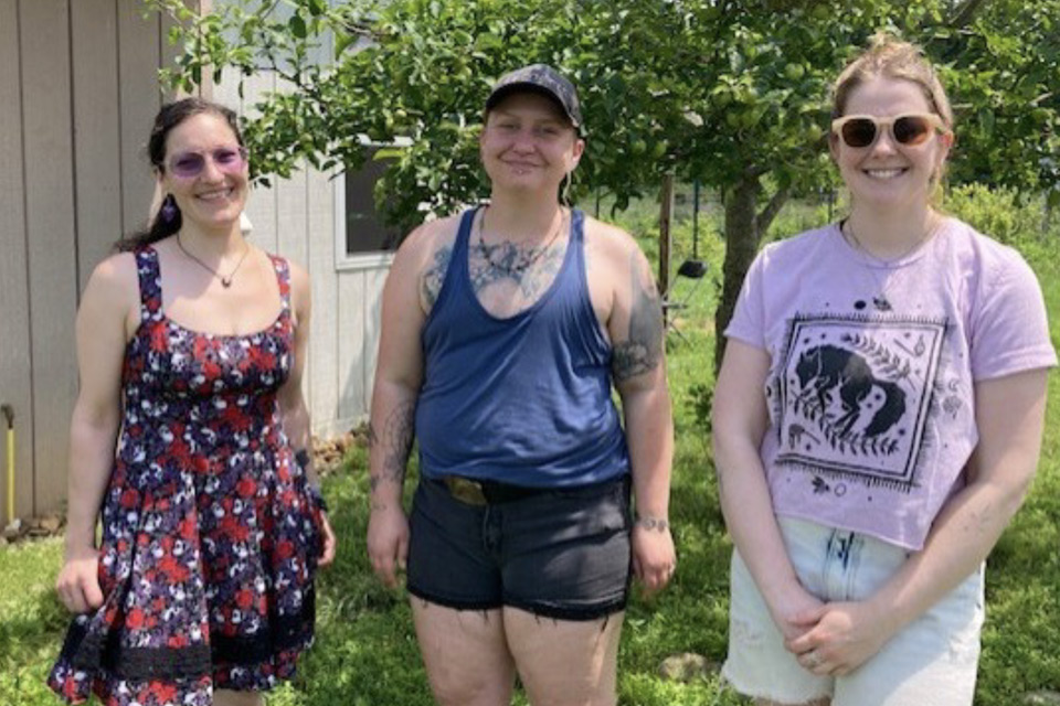 Three artists standing next to each other