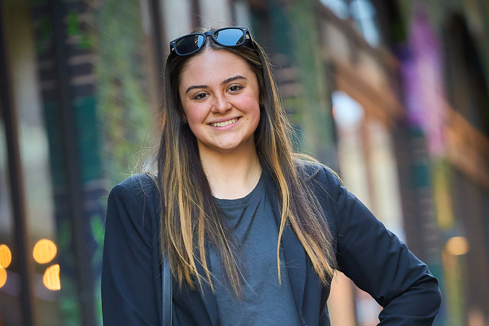 Female student standing outside a hotel entrance