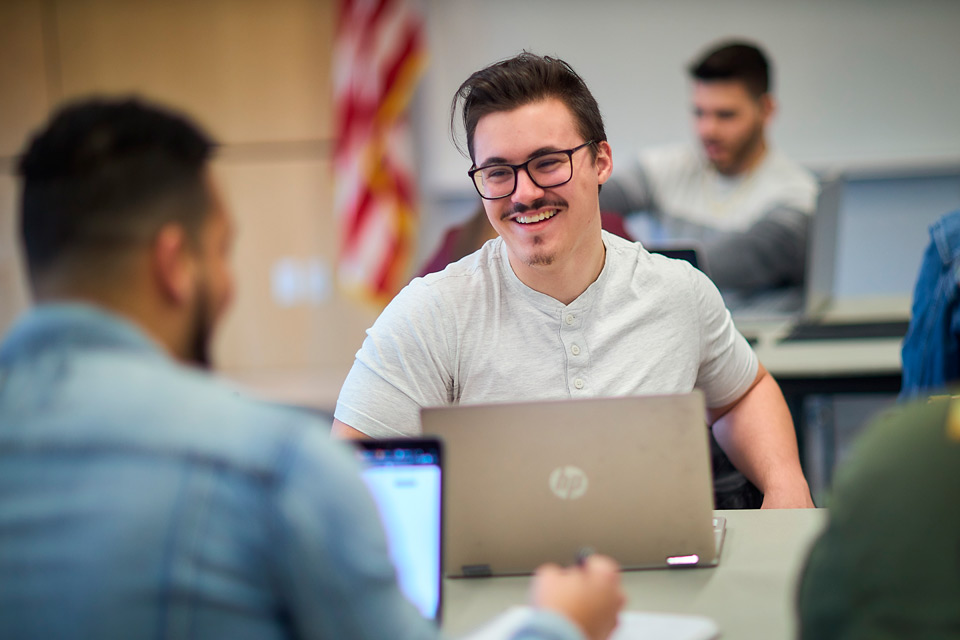 Students looking at laptop