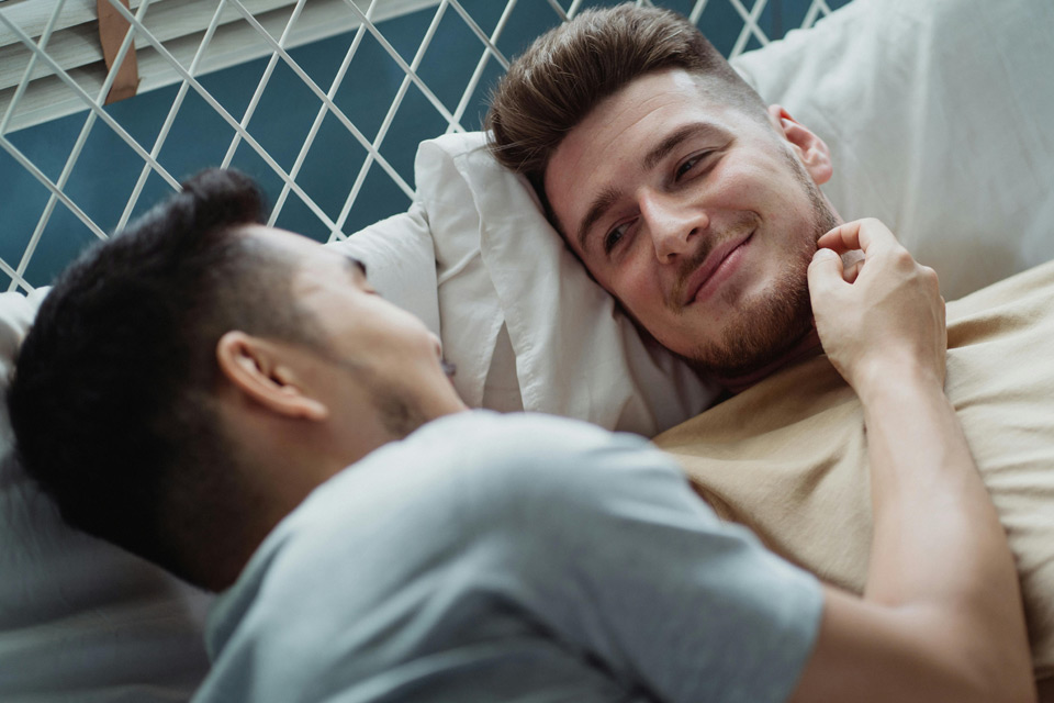 Two guys smiling at each other