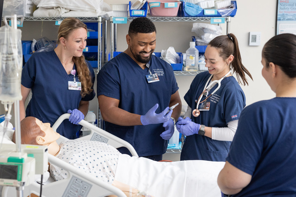 Two female nursing students, one male nurse