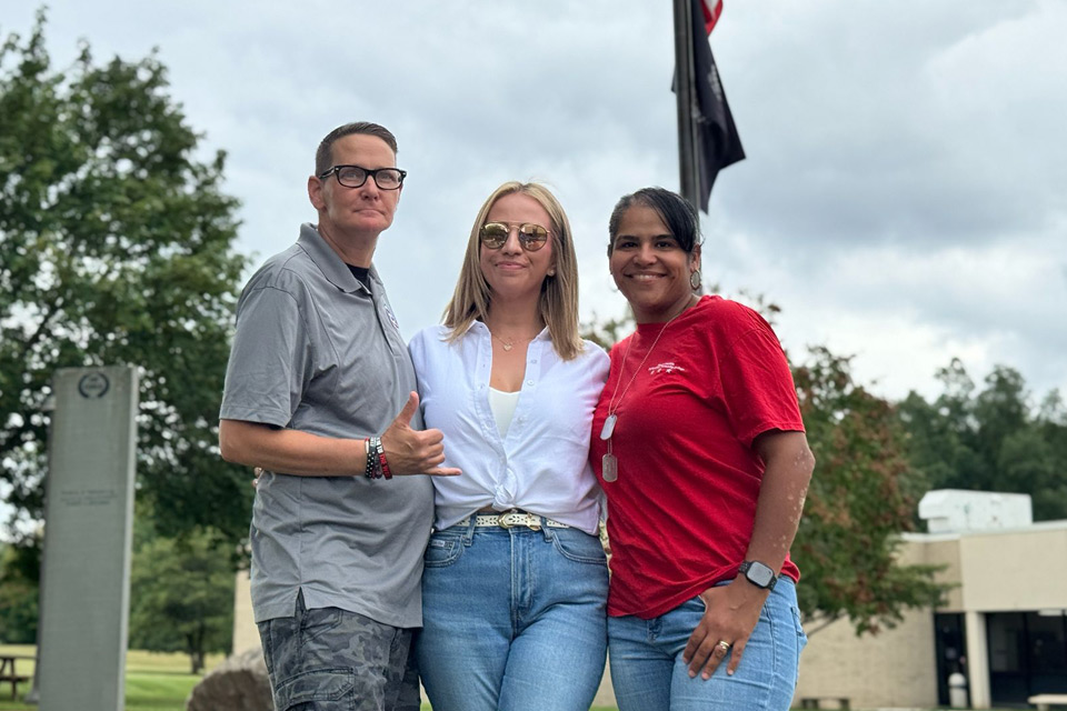 Three veterans standing at the NCC vetrans memorial