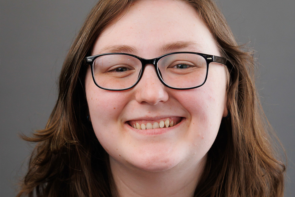 female graduate smiling
