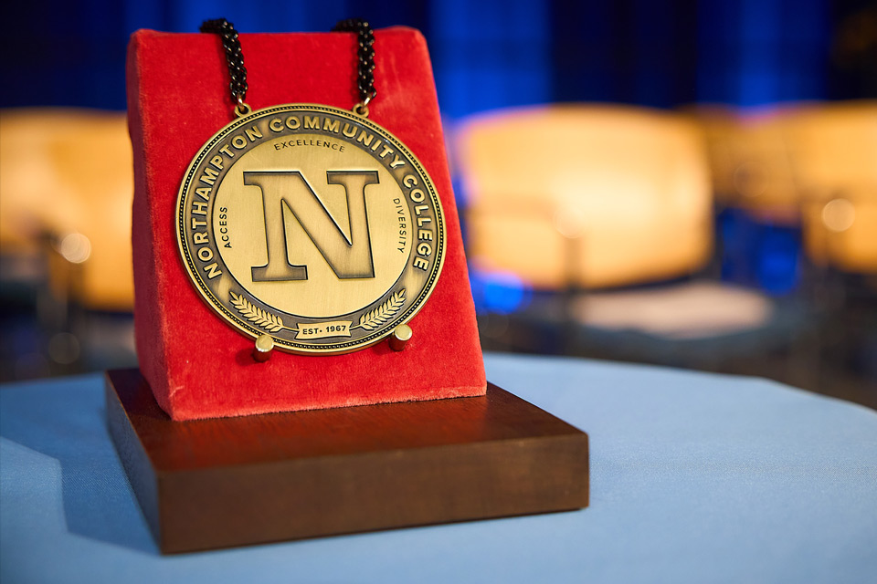 Student pictured with an Honors Program medallion